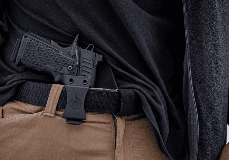 A man wearing his inside the waistband Solace holster by GunfightersINC.