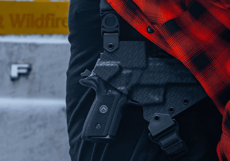 A man wearing the GunfightersINC Spectre Shoulder Holster under a red flannel.