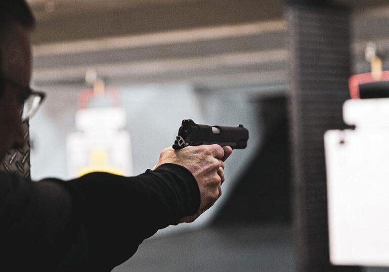 man-firing-gun-at-gun-range